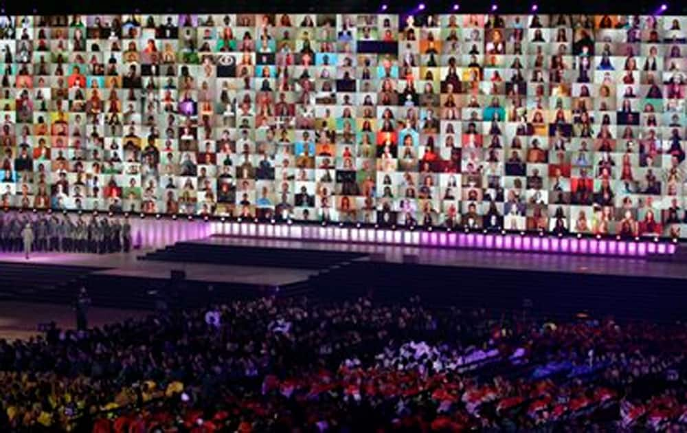 A video wall of faces on screen are displayed during a UNICEF appeal at the opening ceremony for the Commonwealth Games 2014 in Glasgow.