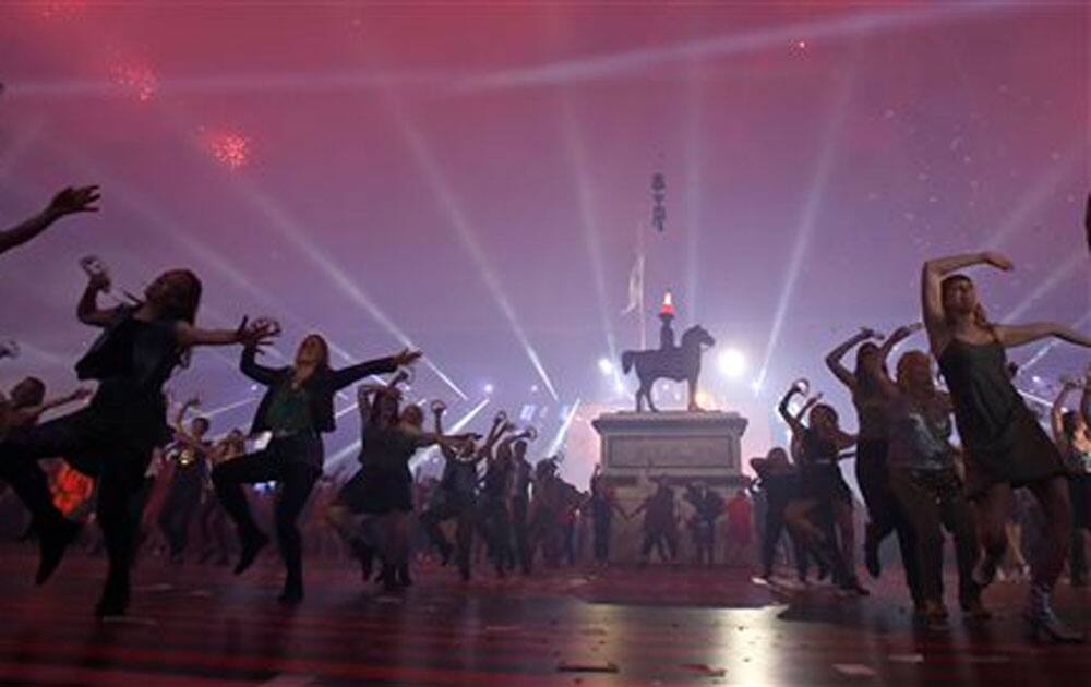 Performers dance as fireworks explode above them at the end of the opening ceremony for the Commonwealth Games 2014 in Glasgow, Scotland.