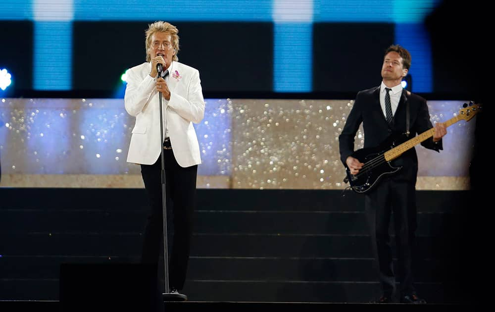 Singer Rod Stewart, left, performs during the opening ceremony for the Commonwealth Games 2014 in Glasgow, Scotland.