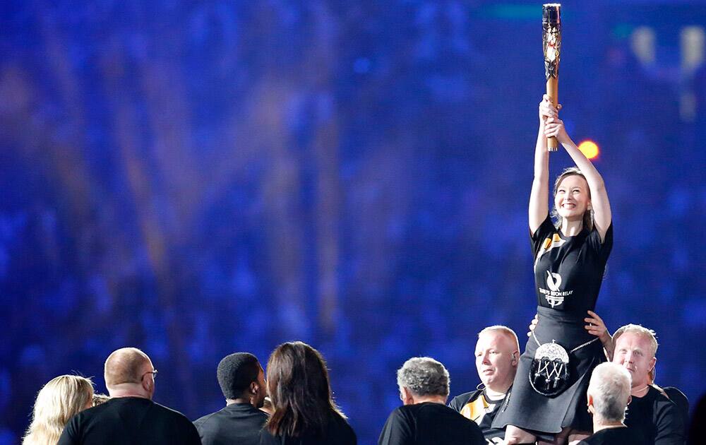 The Queen's Baton is shown to the crowd as it arrives in the stadium during the opening ceremony for the Commonwealth Games 2014 in Glasgow, Scotland.