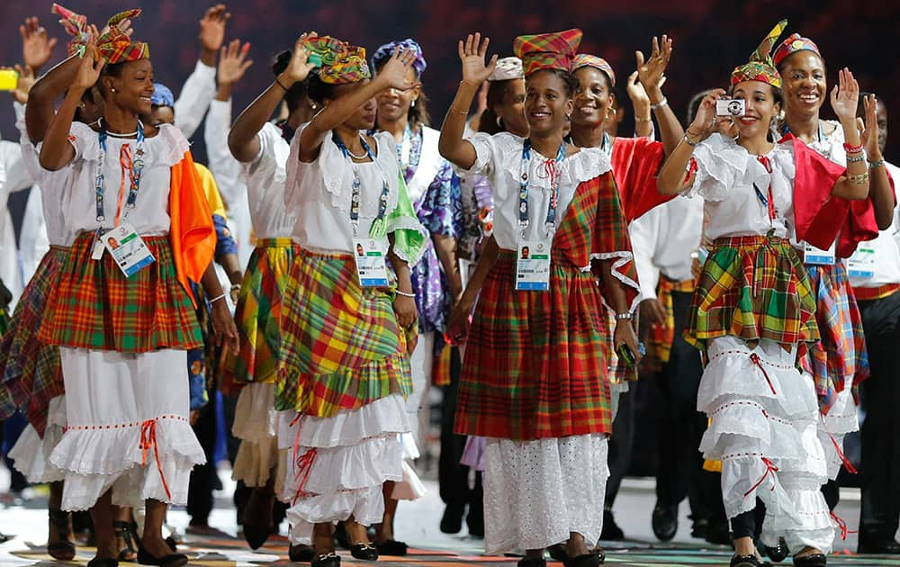 Athletes from St Lucia wave as they walk around the stadium during the opening ceremony for the Commonwealth Games 2014 in Glasgow, Scotland.