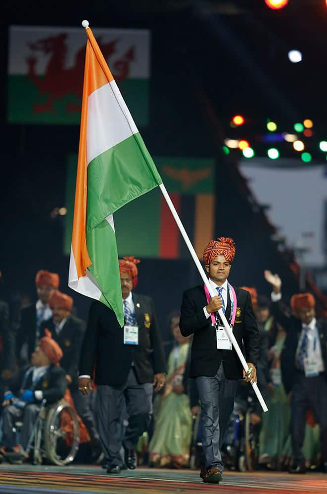 India’s flag bearer Vijay Kumar leads his team during the opening ceremony for the Commonwealth Games 2014 in Glasgow, Scotland.