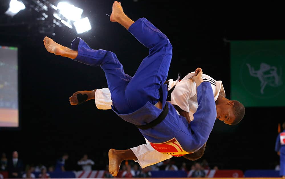 Siyabulela Mabulu of South Africa, in white, throws Jamie Macdonald of Wales during their men's 66kg judo preliminary round bout at the Commonwealth Games Glasgow 2014, in Glasgow, Scotland.