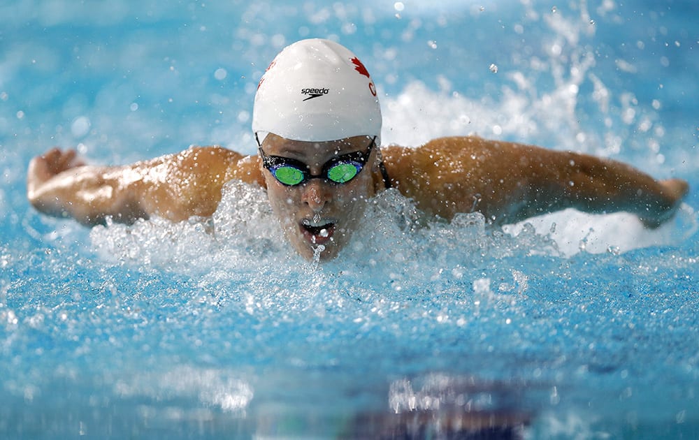 Katerine Savard of Canada competes in a Women's 100m Butterfly heat at the Tollcross International Swimming Centre during the Commonwealth Games 2014 in Glasgow, Scotland.