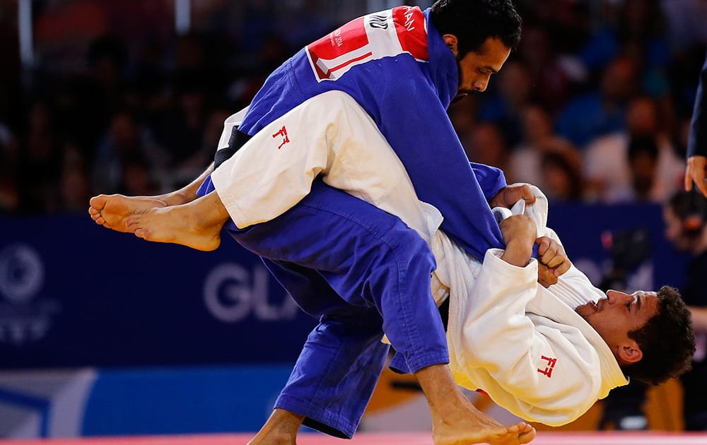 England's Ashley McKenzie, right, fights with India's Navjot Chana during their men -60kg Judo final bout at the Commonwealth Games 2014 in Glasgow, Scotland.