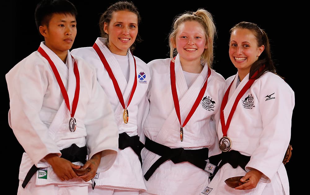 Winner Scotland's Kimberly Renicks , second from right, second placed Shushila Likmabam from India, left, and third placed Chloe Rayner from Australia and Amy Meyer from Australia pose with medals after their women -48kg Judo final bout at the Commonwealth Games 2014 in Glasgow, Scotland.