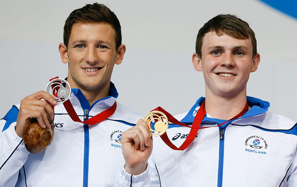 Michael Jamieson, left, with the silver medal and Ross Murdoch, right, with the gold medal both of Scotland during the ceremony after the Men's 200m Breaststroke final at the Tollcross International Swimming Centre during the Commonwealth Games 2014 in Glasgow, Scotland.