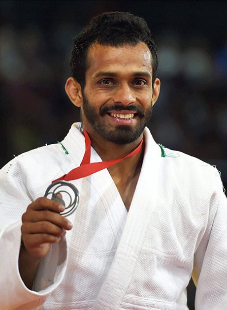 India's Navjot Chana shows his silver medal during the medal ceremony of 60kg men's Judo event at the Commonwealth Games in Glasgow,Scotland.