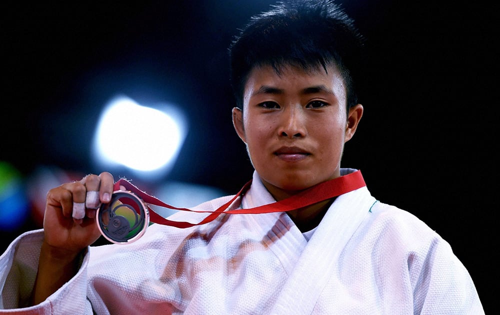 India's Shushila Likmabam shows her silver medal during the 48-kg women's Judo event at the Commonwealth Games in Glasgow, Scotland.