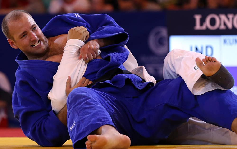 India's Parikshit Kumar and Australia's Jake Andrewartha, left, fight during the Men's +100kg judo bronze medal bout at the Commonwealth Games 2014 in Glasgow, Scotland.