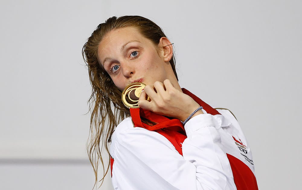 England's Francesca Halsall kisses the gold medal after winning the 50m freestyle swimming competition at the Tollcross International Swimming Centre during the Commonwealth Games 2014 in Glasgow.