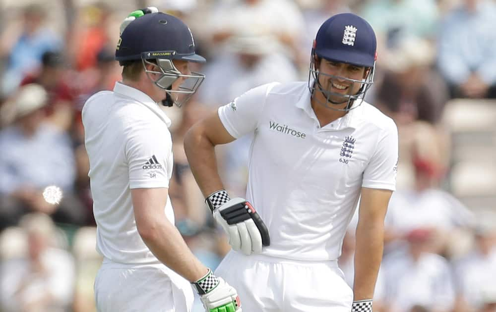 England's opening batsmen captain Alastair Cook, right, and Sam Robson talk between overs during the first day of the third cricket test match of the series between England and India at The Ageas Bowl in Southampton, England.