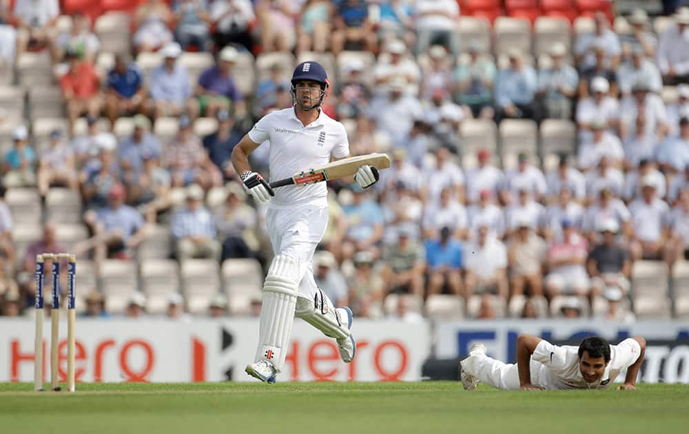 England captain Alastair Cook adds runs as India's Mohammed Shami gets up off the pitch after fielding one of his deliveries during the first day of the third cricket test match of the series between England and India at The Ageas Bowl in Southampton, England.