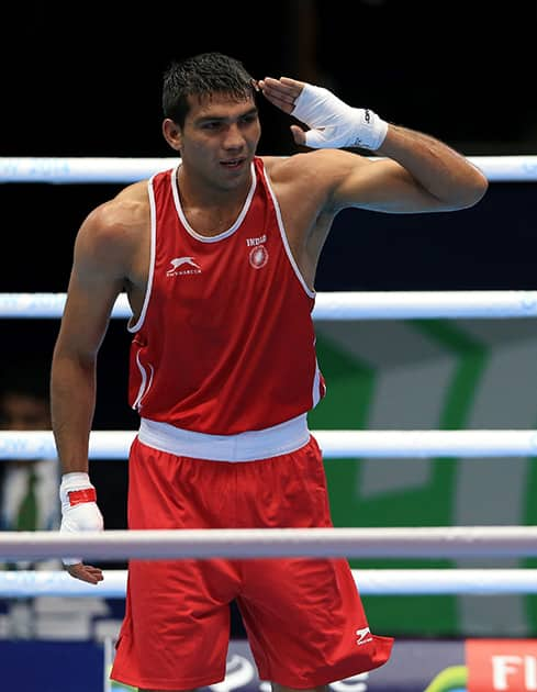 India's Manoj Manoj Kumar celebrates winning his fight against Canada's Arthur Biyarslanov in the Men's Light Welter (64kg) Round of 16, at the SECC during the 2014 Commonwealth Games in Glasgow, Scotland.