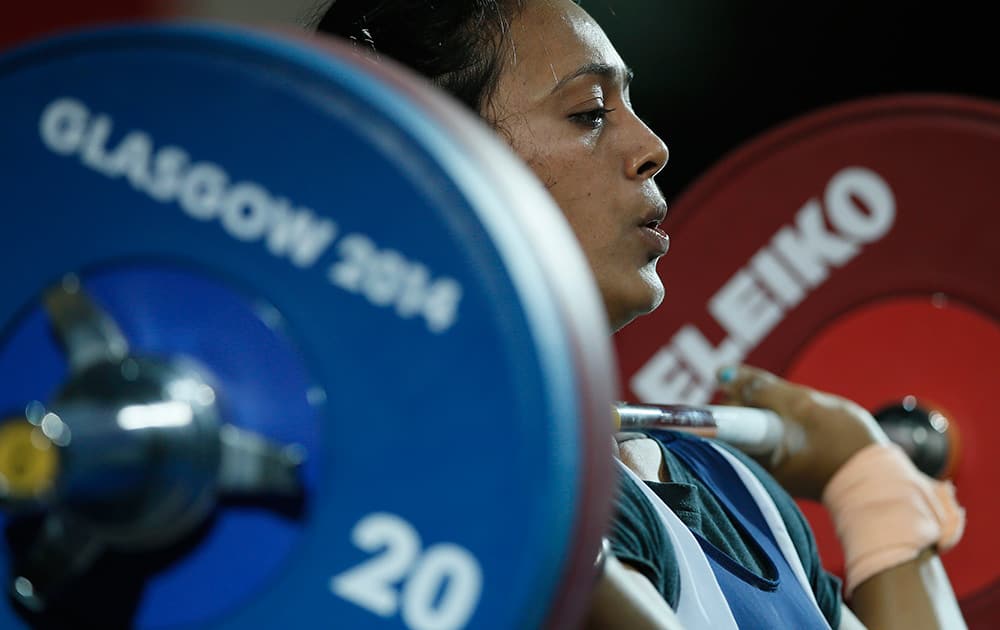 Punam Yadav of India holds the wight as she lifts during the women's 63 kg weightlifting competition at the Commonwealth Games Glasgow 2014, in Glasgow, Scotland.