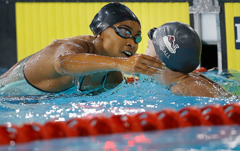 Adrianna Vanderpool Wallace of Bahamas, left, and England's Francesca Halsall celebrate after the Women's 50m Butterfly swimming competition at the Tollcross International Swimming Centre during the Commonwealth Games 2014 in Glasgow, Scotland.