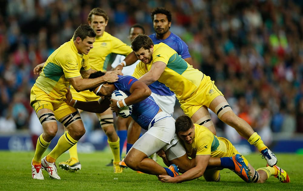 Ed Jenkins, left, of Australia with teammates Liam Gill, second right, and Sean McMahon, on floor, tackle Levi Asifaanatala of Samoa during their rugby sevens bronze medal match at the Commonwealth Games Glasgow 2014, in Glasgow, Scotland.