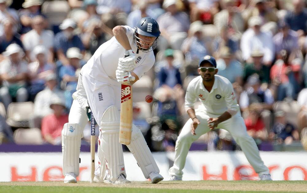 England's Gary Ballance hits an edge to be caught out by India's captain and wicketkeeper Mahendra Singh Dhoni off the bowling of India's Rohit Sharma during the second day of the third cricket test match of the series between England and India at The Ageas Bowl in Southampton, England.