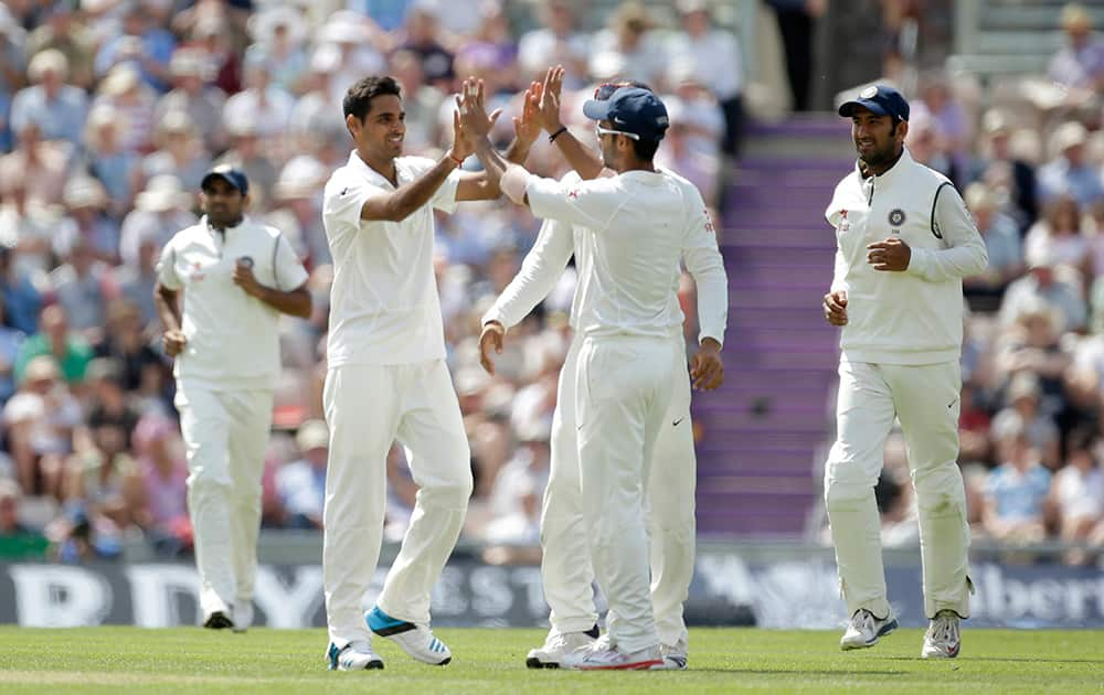 India's Bhuvneshwar Kumar celebrates taking the wicket of England's Joe Root during the second day of the third cricket Test match of the series between England and India at The Ageas Bowl in Southampton, England.