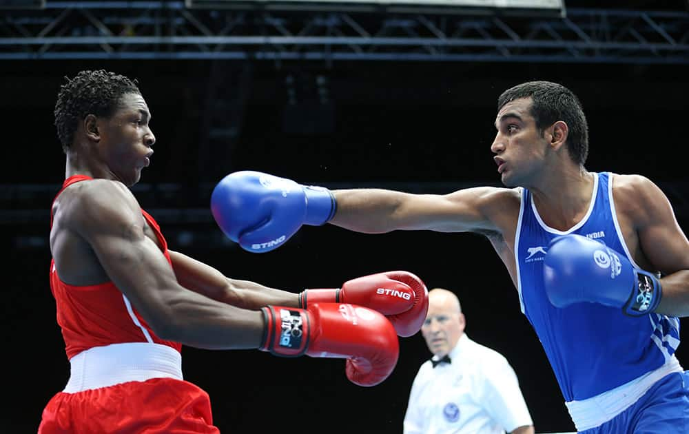 India's Mandeep Jangra, right, tries to land a punch on Jamaica's Kestna Davis during their in the men's boxing welterweight preliminaries round bout at the Commonwealth Games Glasgow 2014, Glasgow.