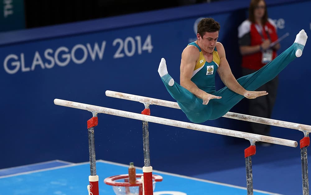 Australia's Jack Rickards performs on the bars during the men's team qualifying session in the gymnastics competition at the Commonwealth Games Glasgow 2014, in Glasgow.