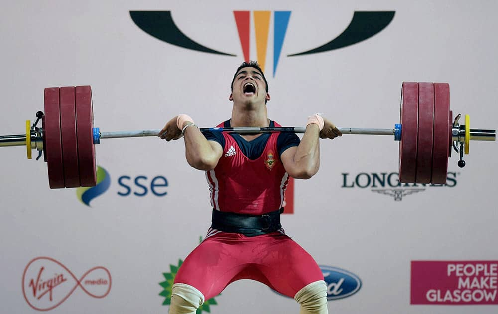 India's Vikas Thakur lifts on his way to win silver in the Men's Weightlifting 85kg category event at Scottish Exhibition and Conference Centre at the Commonwealth Games 2014 in Glasgow.