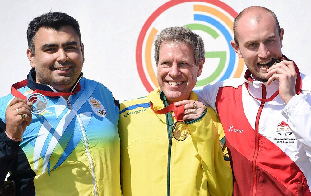 Silver medallist Gagan Narang, Australia's Gold Medallist Warren Potent and England's Kenneth (bronze) during the medal ceremony of the 50m Rifle Prone men final event during the Glasgow 2014 Commonwealth Games at Barry Buddon Shooting Centre in Glasgow.