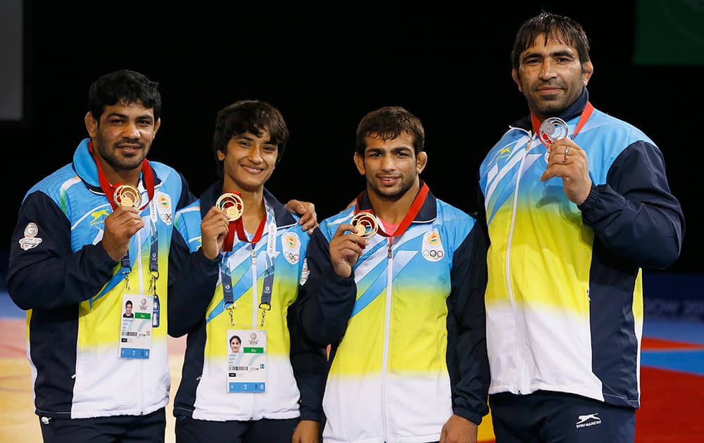 India's wrestling medalists Sushil Kumar, left with gold, Vinesh, second left with gold, Amit Kumar Amit, second right with gold and Rajeev Tomar, right, with silver pose with their medals at the Scottish Exhibition Conference Centre during the Commonwealth Games 2014 in Glasgow.