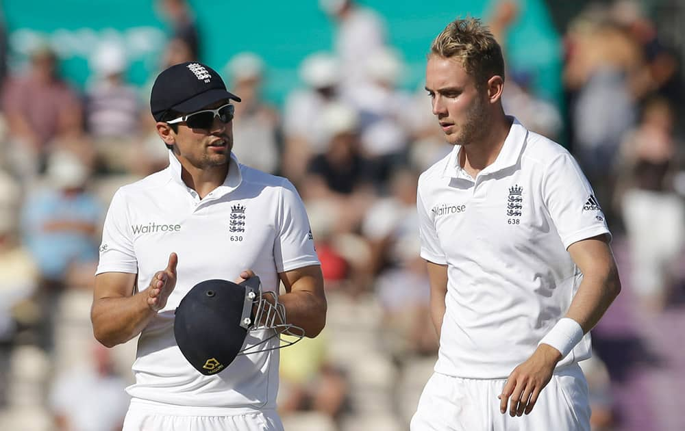 England captain Alastair Cook, left, talks with Stuart Broad before Broad bowled an over during the third day of the third cricket Test match of the series between England and India at The Ageas Bowl in Southampton.