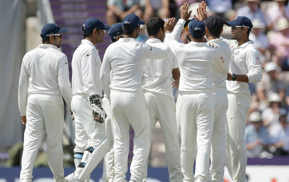 India's Bhuvneshwar Kumar celebrates with his teammates after taking the wicket of England's Sam Robson during the fourth day of the third cricket test match of the series between England and India at The Ageas Bowl in Southampton, England.