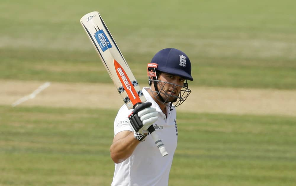 England captain Alastair Cook celebrates reaching 50 runs during the fourth day of the third cricket Test match of the series between England and India at The Ageas Bowl in Southampton, England.