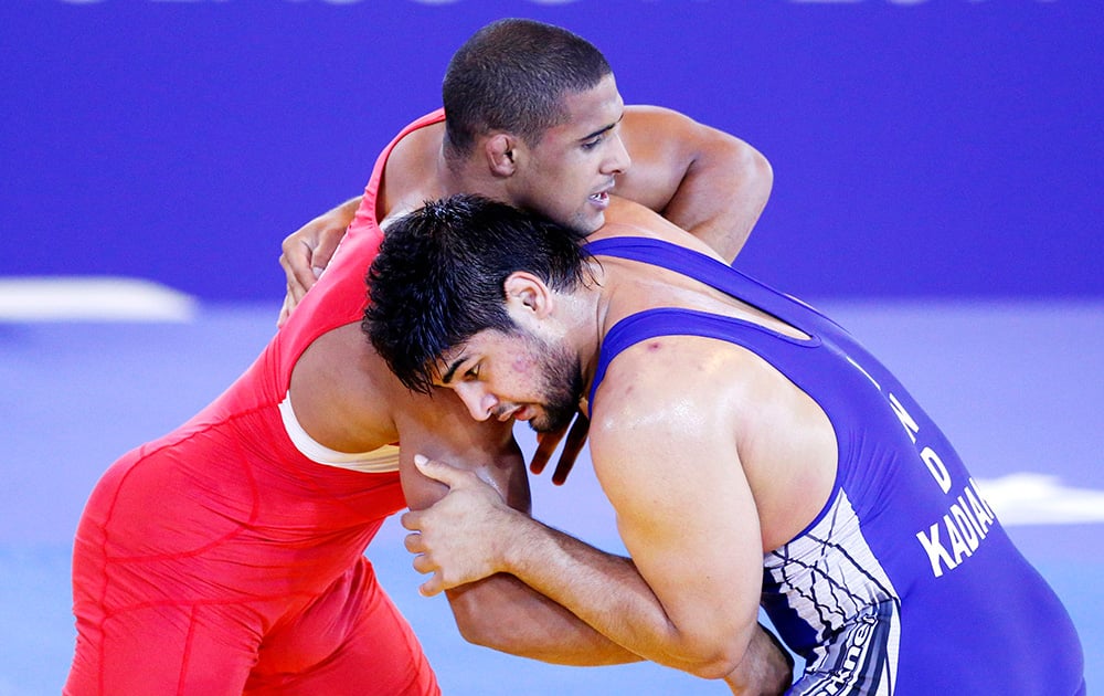 England's Leon Rattigan and India's Satywart Kadian challenge during the freestyle 97kg semifinal wrestling at the Commonwealth Games Glasgow 2014, in Glasgow, Scotland.