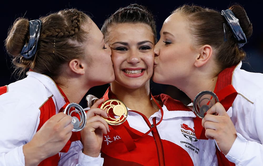 Ruby Harold with silver, left, Claudia Fragapane with gold, centre, and Hannah Whelan with bronze, right, all of England with their medals after the Women's All-Around gymnastics competition at the Scottish Exhibition Conference Centre during the Commonwealth Games 2014 in Glasgow, Scotland.