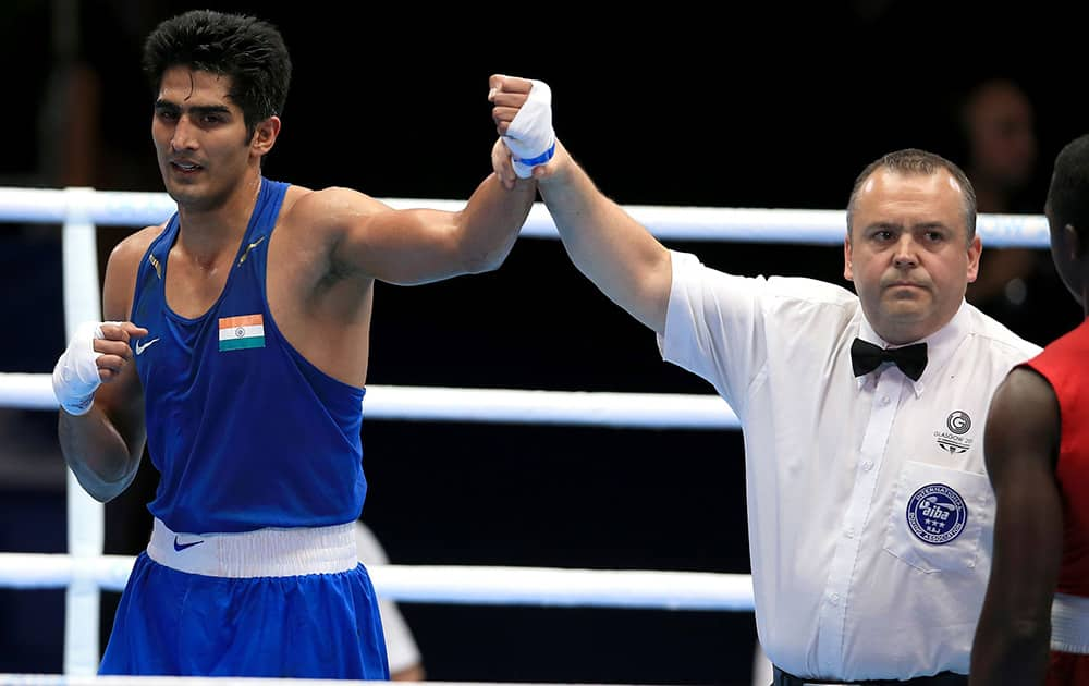 Vijender celebrates victory against Trinidad and Tobago's Aaron Prince after their Men's middle weight quarterfinal during the 2014 Commonwealth Games in Glasgow, Scotland.