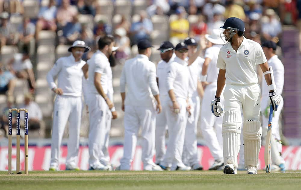 India's Rohit Sharma, right, walks off the field of play after losing his wicket off the bowling of England's James Anderson during the fifth and final day of the third cricket Test match of the series between England and India at The Ageas Bowl in Southampton, England.