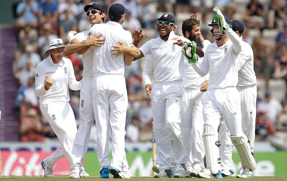 England's James Anderson celebrates with his teammates after catching out India's Bhuvneshwar Kumar off a Moeen Ali delivery during the fifth and final day of the third cricket test match of the series between England and India at The Ageas Bowl in Southampton, England.