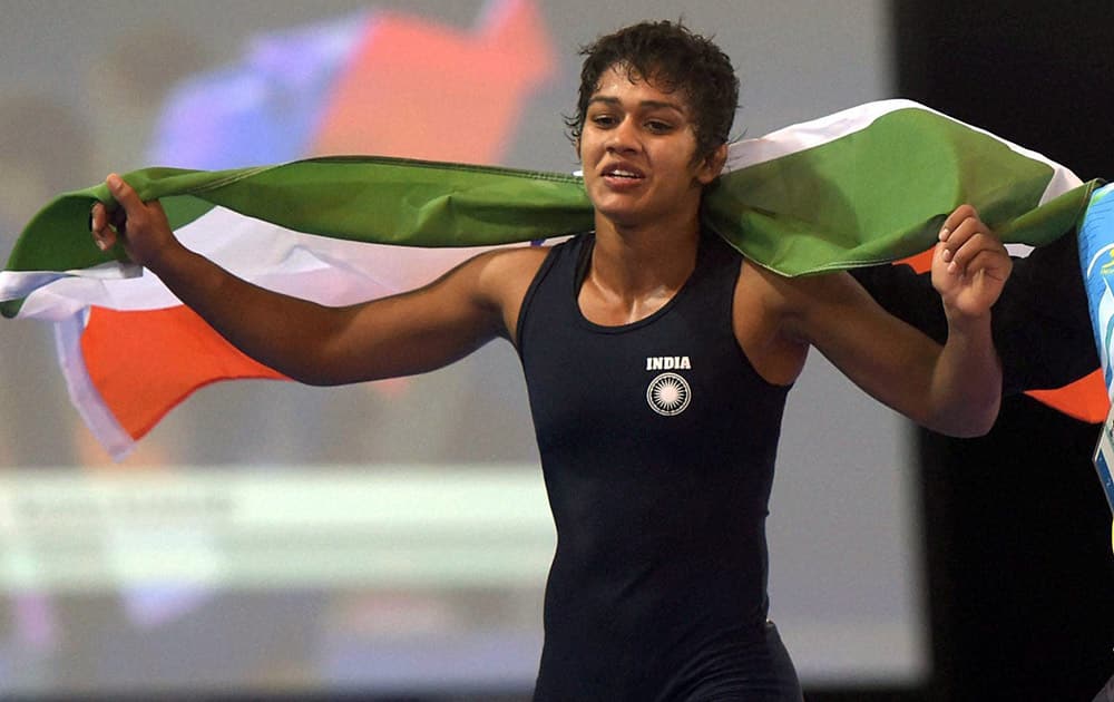 Babita Kumari celebrates after winning the gold medal against Canada's Brittanee Laverdure during the women's Freestyle Wrestling 55kg Final match at the Scottish Exhibition Conference Centre during the Commonwealth Games 2014 in Glasgow.