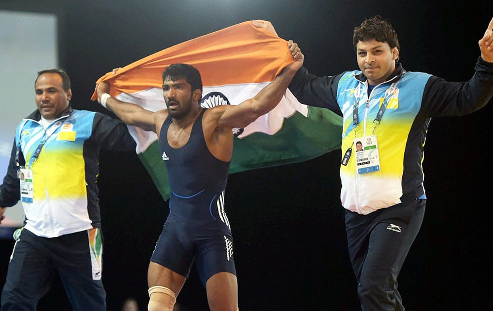 Yogeshwar Dutt celebrates after winning the Gold Medal against Canada's Jevon Balfour during the Men's Freestyle Wrestling65kg Final match at the Scottish Exhibition Conference Centre during the Commonwealth Games 2014 in Glasgow.