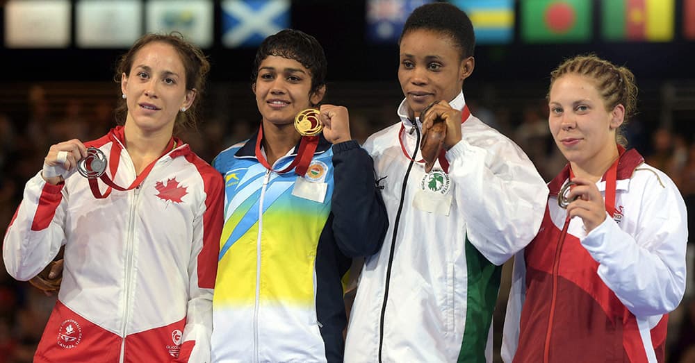 Gold medalist Babita Kumari, Silver medalist Brittanee Laverdure,with gold medal after medal ceremony of the women's Freestyle Wrestling 55kg Final match at the Scottish Exhibition Conference Centre during the Commonwealth Games 2014 in Glasgow.