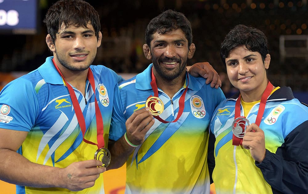 India's gold medalist Yogeshwar Dutt,silver medalist Geetika Jakhar and Bronze medalist Pawan Kumar at the Scottish Exhibition Conference Centre during the Commonwealth Games 2014 in Glasgow.