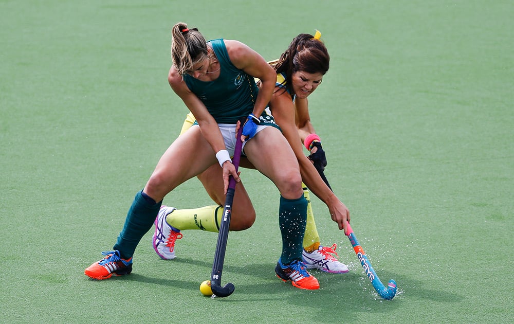 Australia's Anna Flanagan, right, vies for the ball with South Africa's Dirkie Chamberlain during their women's semi final hockey match during the Commonwealth Games 2014 in Glasgow, Scotland.