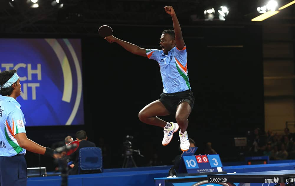 India's Anthony Arputharaj and Sharat Kamal Achanta celebrate after defeating Singapore's Jian Zhan and Zi Yang in the Men's Doubles Table tennis semi-final at Hampden Park Stadium during the Commonwealth Games 2014 in Glasgow, Scotland.