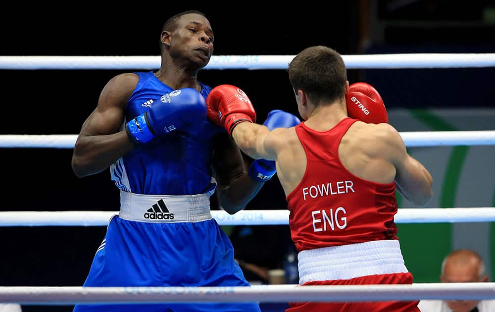 England's Anthony Fowler, right, punches Zambia's Benny Muziyo in the Men's Middle (75kg) Semi-final 2 boxing match, at the SECC, during the Commonwealth Games 2014, in Glasgow.