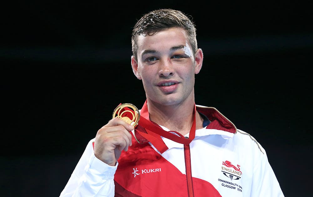 Gold medal winner Scott Fitzgerald of England holds his medal after he defeated India's Mandeep Jangra in the men's welterweight (69kg) boxing final at the 2014 Commonwealth Games in Glasgow, Scotland.