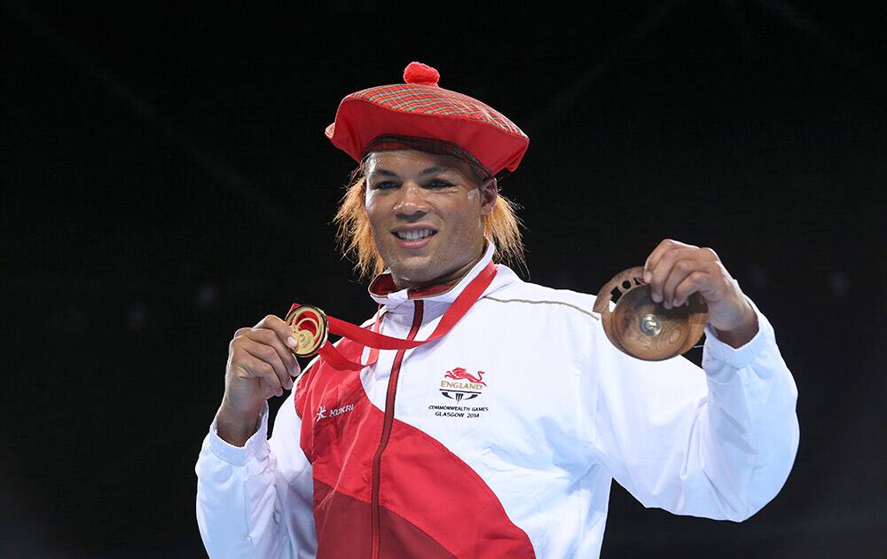 Gold medal winner Joseph Joyce from England poses during the medals ceremony after defeating Australia's Joseph Goodall in the men's super heavyweight boxing final at the 2014 Commonwealth Games in Glasgow, Scotland.