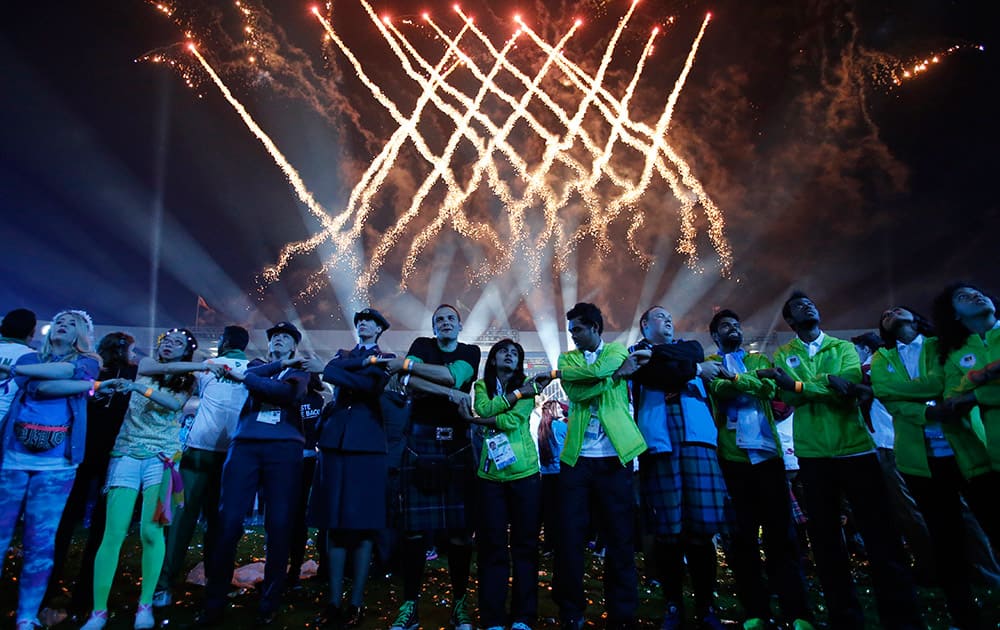 Games makers and athletes join hands as they sing the traditional Scottish song Auld Lang Syne at the end of the Closing Ceremony for the Commonwealth Games Glasgow 2014, at Hampden Park stadium, in Glasgow, Scotland.