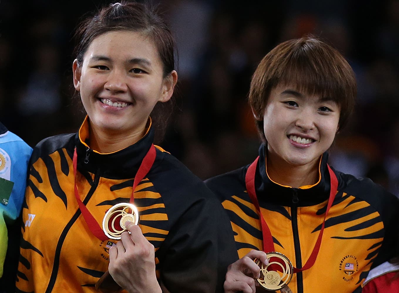 Malaysia's Khe Wei Woon, left, and Vivian Kah Mun Hoo, right, pose with their gold medals after their victory over India's Jwala Gutta and Ashwini Ponnappa at the end of their women's doubles Badminton match at the Emirates Arena during the Commonwealth Games Glasgow 2014.