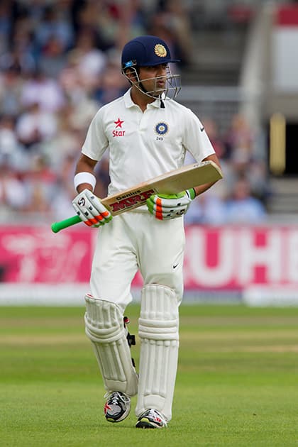 Gautam Gambhir walks from the pitch after losing his wicket for 4 off the bowling of England's Stuart Broad at Old Trafford cricket ground on the first day of the fourth test match of their five match series in Manchester, England.