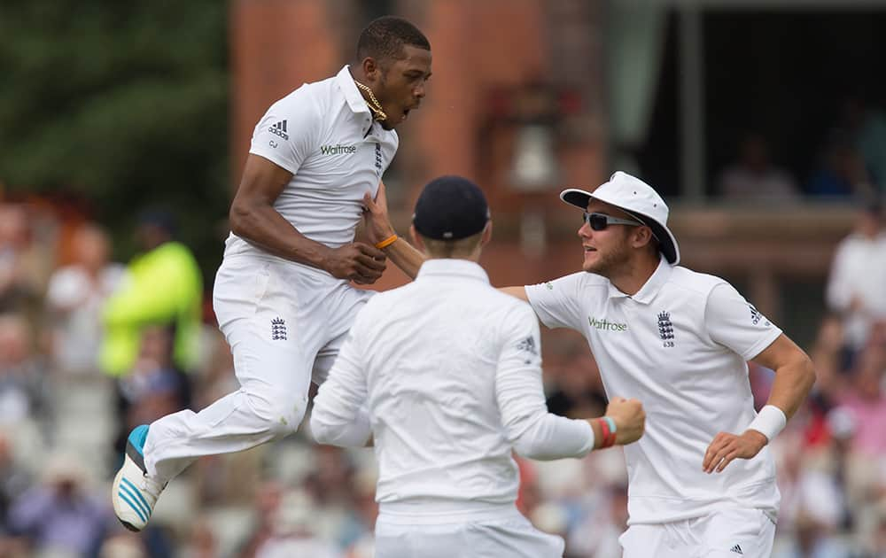 England's Chris Jordan celebrates after taking the wicket of India's Ajinkya Rahane for 24 at Old Trafford cricket ground on the first day of the fourth test match of their five match series, in Manchester, England.