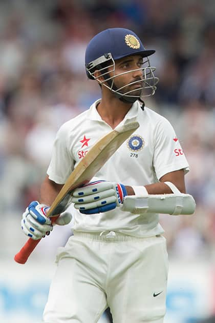 India's Ajinkya Rahane walks from the pitch after losing his wicket for 24 off the bowling of England's Chris Jordan at Old Trafford cricket ground on the first day of the fourth test match of their five match series, in Manchester, England.